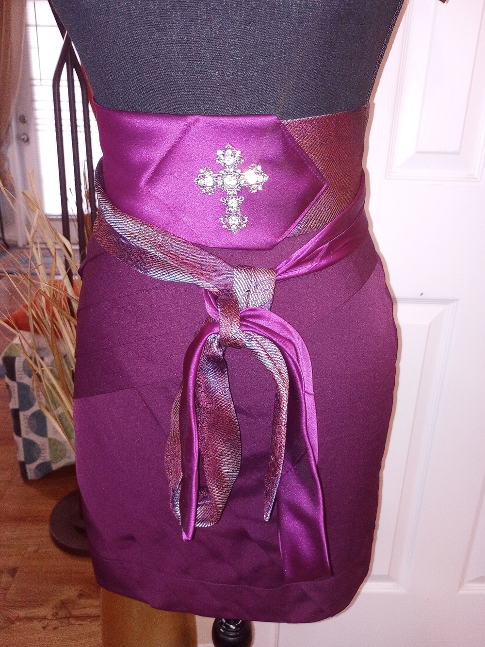 Two Toned Tie Belt With A Jeweled Brooch In The Center